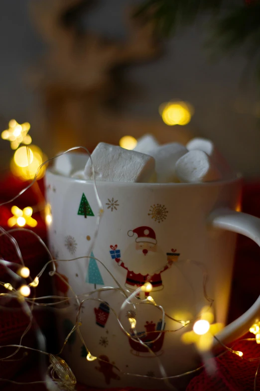 a cup of hot chocolate with marshmallows in it, a still life, pexels, christmas lights, square, low detail, shot with sony alpha