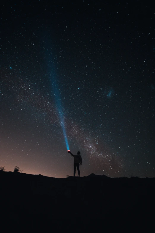 a person standing on top of a hill under a sky full of stars, pexels contest winner, light and space, holding a light saber, standing in the solar system, museum quality photo, selfie photo