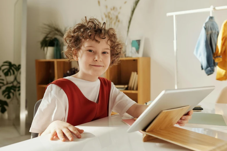 a little boy that is sitting at a table, trending on pexels, happening, took on ipad, avatar image, curly blonde hair | d & d, school class