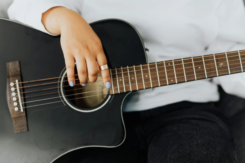 a close up of a person holding a guitar, profile image