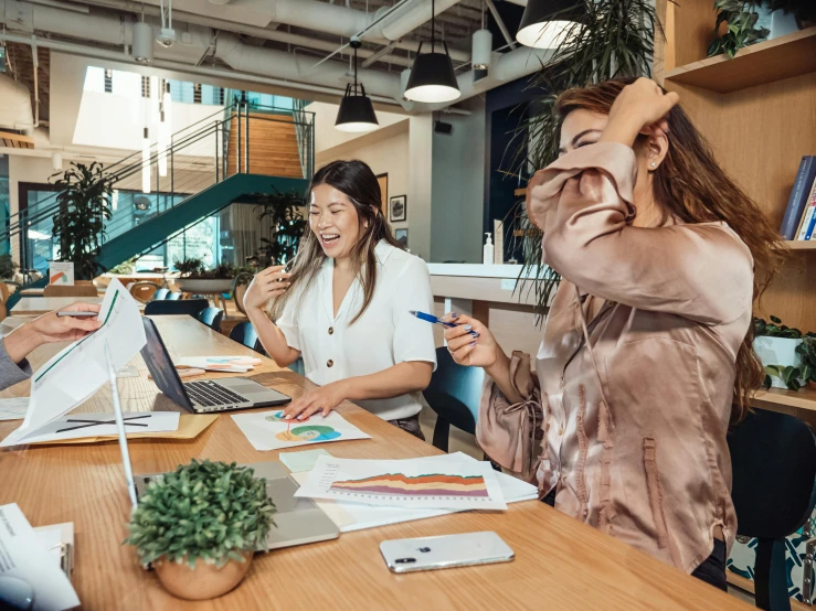 a group of people sitting around a wooden table, a cartoon, trending on pexels, in an call centre office, woman holding another woman, 9 9 designs, bending down slightly