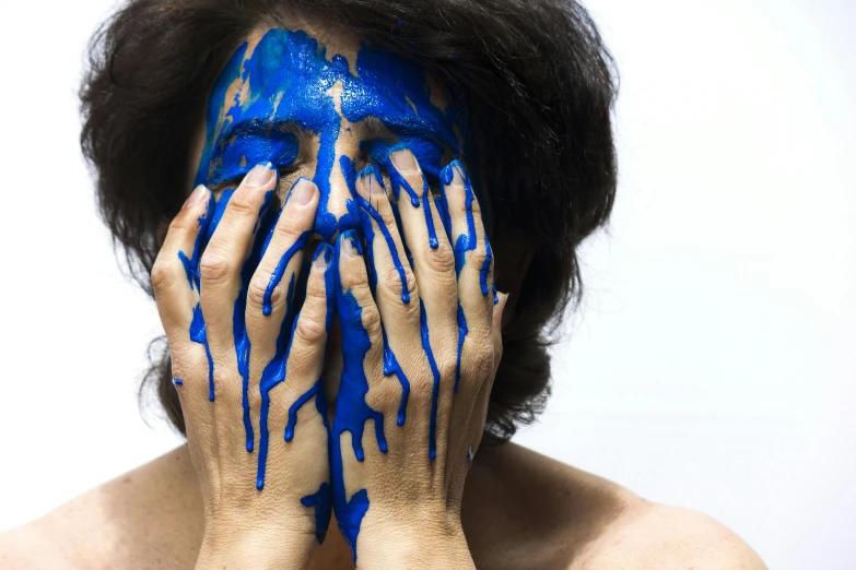 a man with blue paint on his face covering his face, a hyperrealistic painting, inspired by Yves Klein, pexels contest winner, woman crying, hands, neri oxman, lacquered