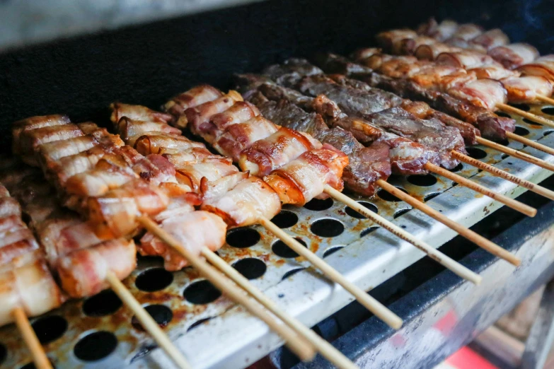 a close up of skewered meat on a grill, pexels contest winner, sōsaku hanga, lined up horizontally, melbourne, 💋 💄 👠 👗, bian lian