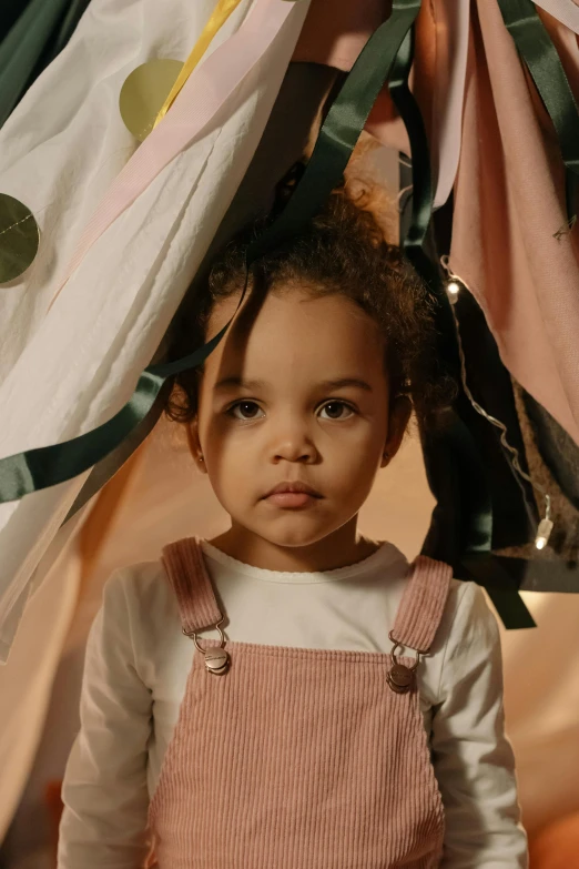 a little girl that is standing under a tent, promo photo, ribbons, zoë kravitz, portrait featured on unsplash