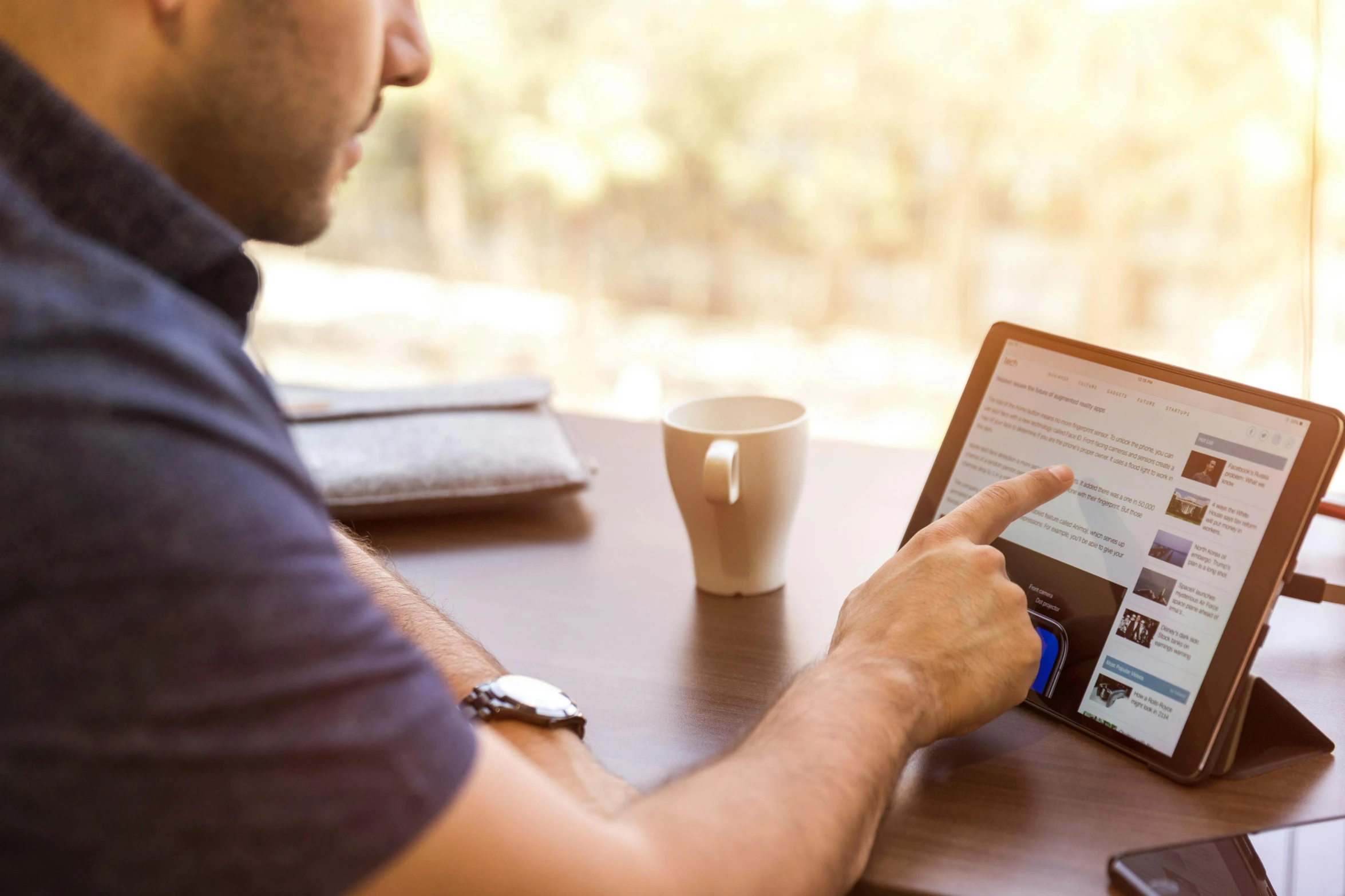 a man sitting at a table using a tablet computer, pexels contest winner, papyrus, natural morning light, thumbnail, over-shoulder shot