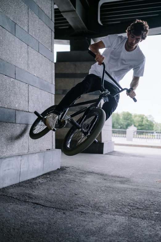 a man flying through the air while riding a bike, pexels contest winner, realism, on a large marble wall, headshot, levers, boys