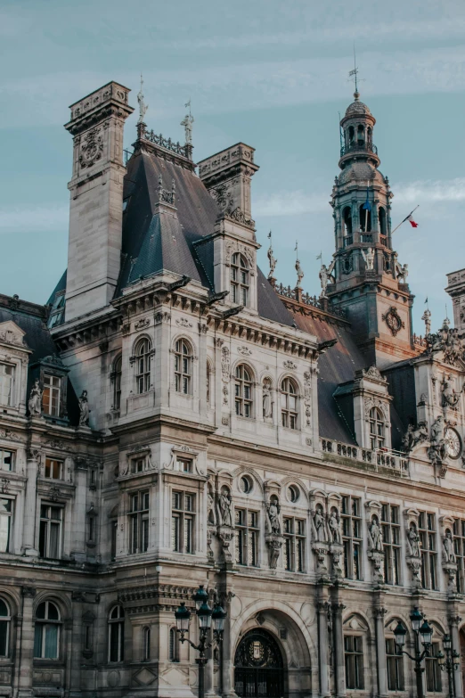 a large building with a clock tower on top of it, pexels contest winner, paris school, turrets, town hall, cinematic still, ornate