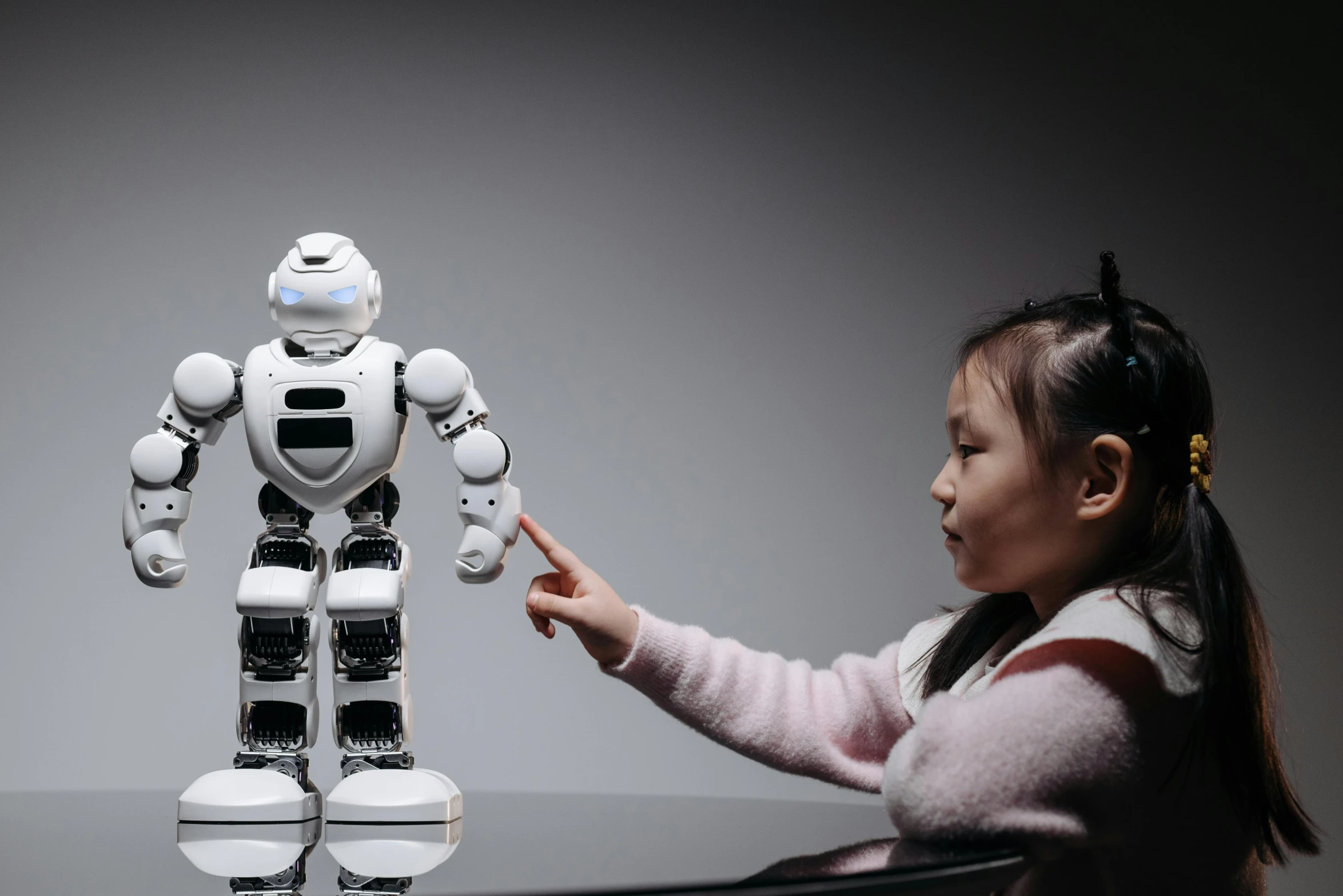 a little girl pointing at a robot on a table, unsplash, realistic », white mech bot, fan favorite, kim hyun joo