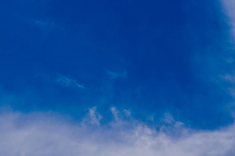 a large jetliner flying through a blue sky, an album cover, unsplash, minimalism, cumulus, electric blue, ignant, color ( sony a 7 r iv