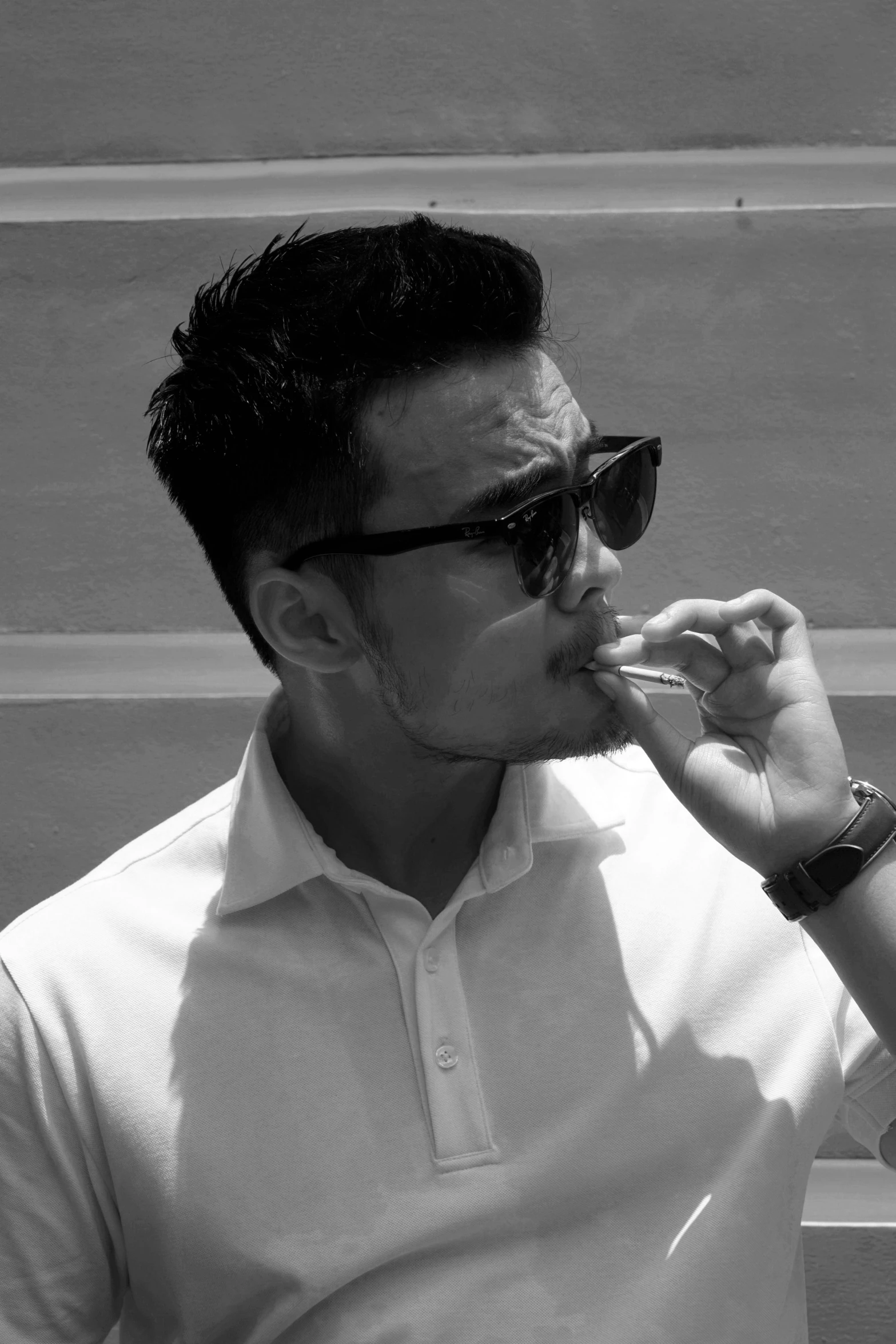 a black and white photo of a man smoking a cigarette, inspired by Gang Se-hwang, reddit, with sunglass, profile image, pompadour, jonny wan