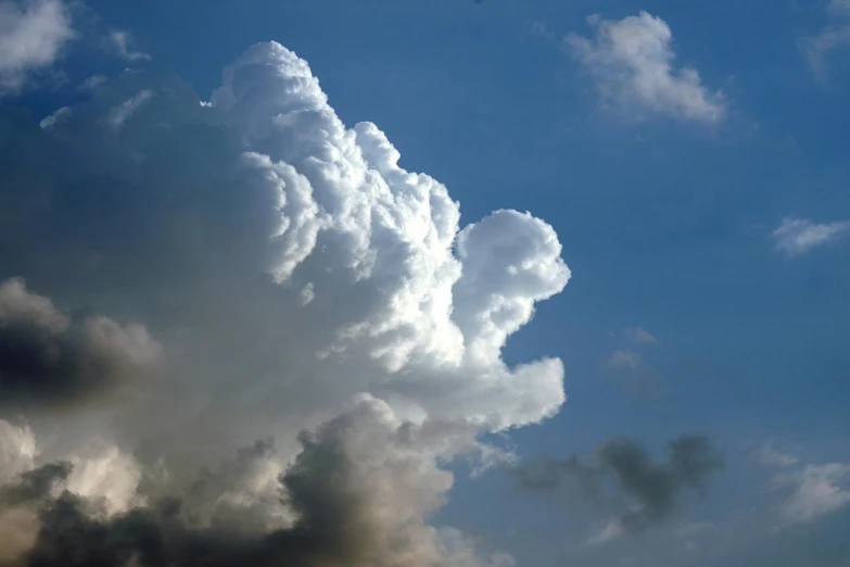 a jetliner flying through a cloudy blue sky, by Jan Rustem, unsplash, romanticism, giant cumulonimbus cloud, thick white detailed smoke, ignant, closeup photograph