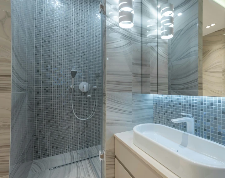 a bath room with a sink a mirror and a shower, a mosaic, by Konrad Witz, pexels contest winner, light and space, blue gray, heavenly marble, high gloss, glowing with silver light