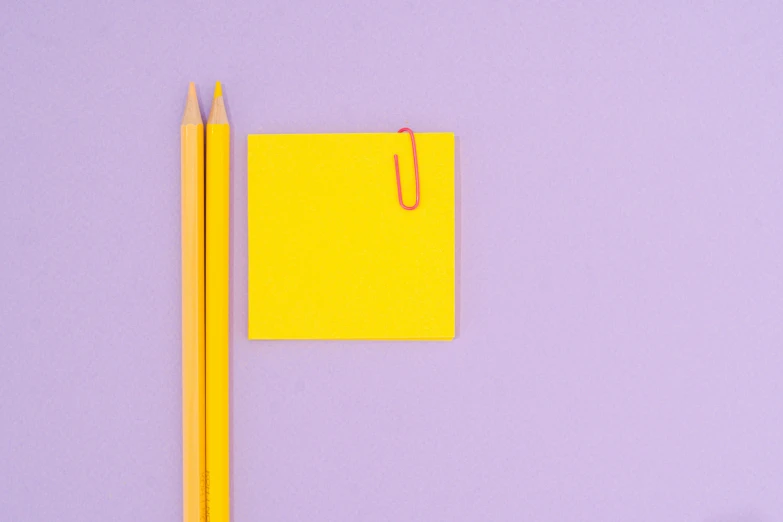 a yellow piece of paper next to a yellow pencil, by Andrei Kolkoutine, trending on pexels, postminimalism, light purple, square shapes, colorful image, shot on sony a 7 iii
