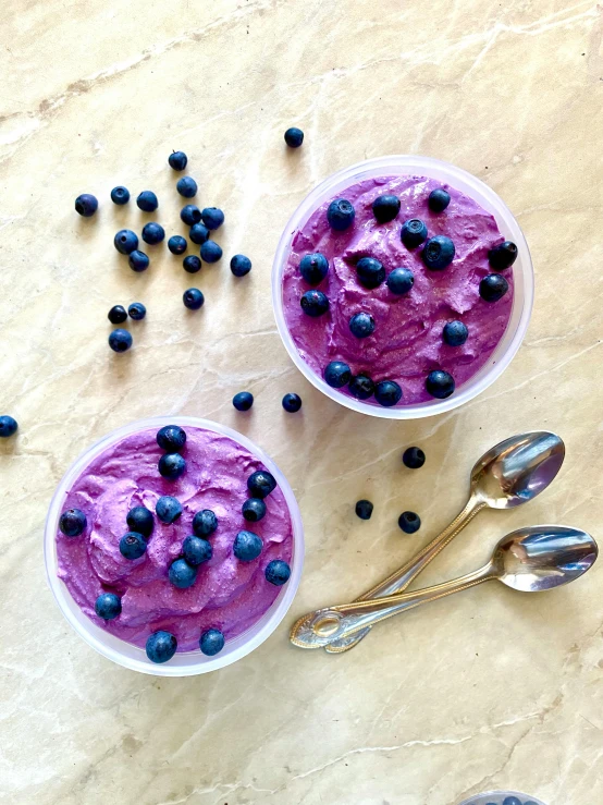 a couple of bowls filled with blueberries next to spoons, purple alien, sea of parfait, bio-inspired, vibrantly lush