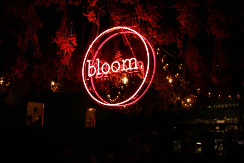 a neon sign hanging from the side of a tree, by Hyman Bloom, unsplash contest winner, bloomed lighting, nightclub, inside the flower, reddish exterior lighting