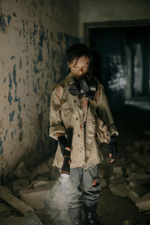 a man wearing a gas mask standing in an abandoned building, by Elsa Bleda, pexels contest winner, walking boy, dressed as a scavenger, ( ( theatrical ) ), toys