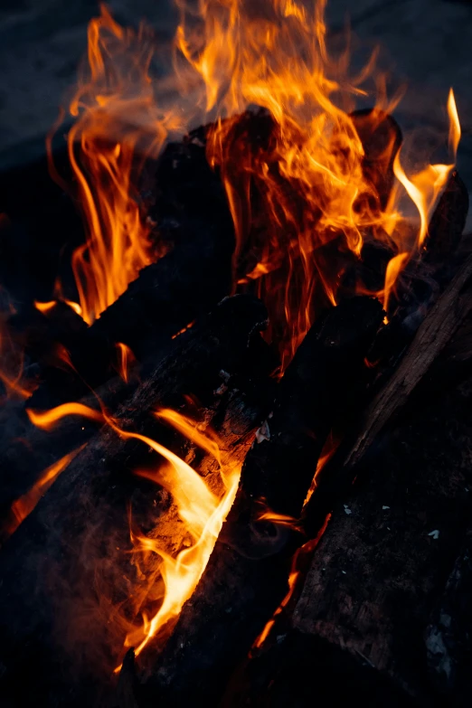 a close up of a fire with flames coming out of it, pexels contest winner, warm wood, avatar image, outdoor photo, low detail