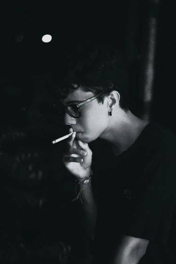 a black and white photo of a woman smoking a cigarette, pexels contest winner, serial art, teenage boy, dark shades, late night, androgynous person