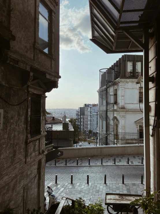 a view of a city from a window, a picture, by Lucia Peka, unsplash contest winner, neoclassicism, istanbul, sloped street, ground-level view, late afternoon light