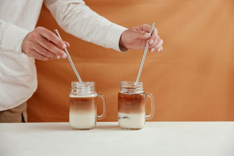 a couple of mason jars sitting on top of a table, aussie baristas, using fork, silver，ivory, thumbnail