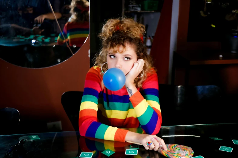 a woman blowing a bubble while sitting at a table, flickr, rainbow clothes, square, gambling, striped