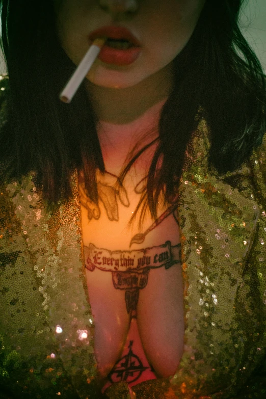 a woman with a cigarette in her mouth, a tattoo, inspired by Nan Goldin, trending on reddit, transgressive art, disco club of the occult, closeup of arms, low quality photo, melanie martinez