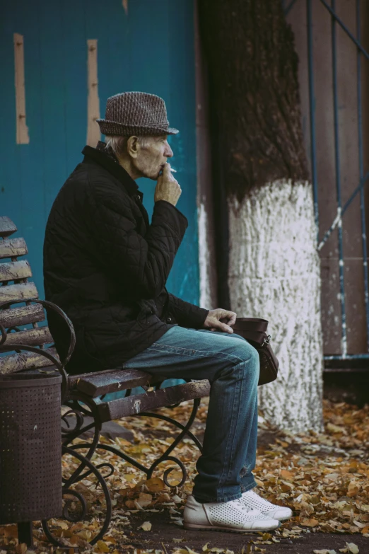 a man sitting on a bench smoking a cigarette, pexels contest winner, grandfatherly, in fall, street corner, profile image