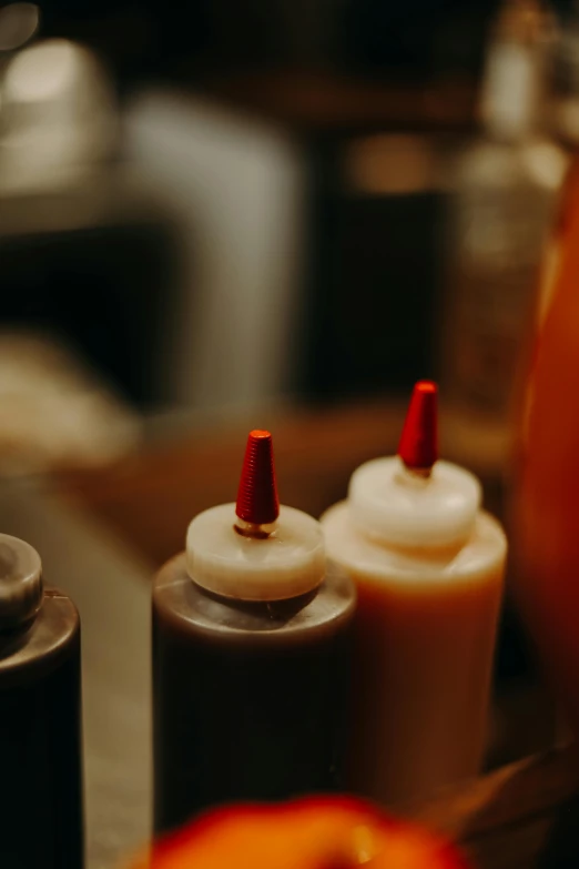 a group of condiments sitting on top of a table, unsplash, renaissance, orange candle flames, worn, low detail, vapor