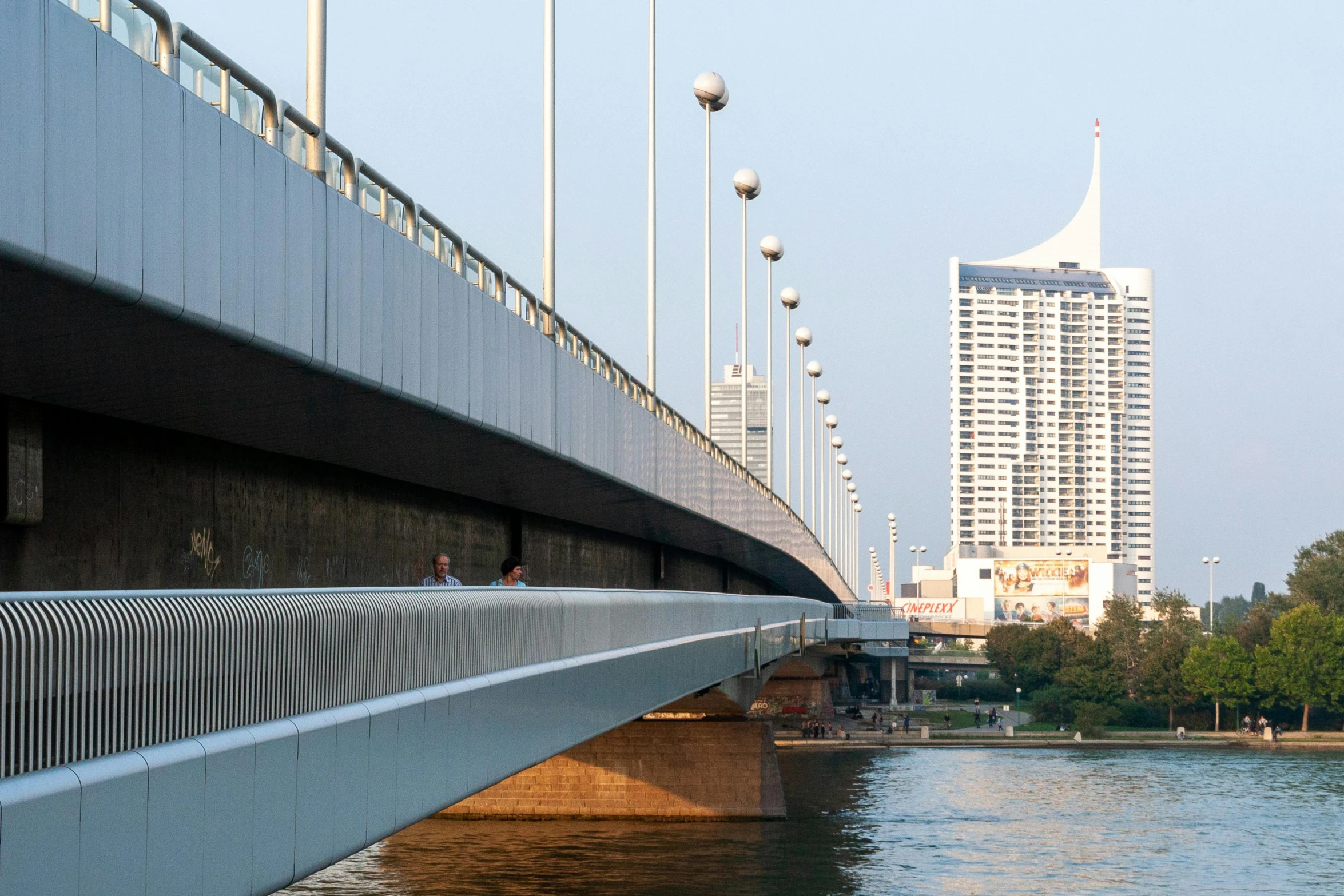 a bridge over a body of water with tall buildings in the background, unsplash contest winner, bauhaus, bangkok, streamline moderne, 2000s photo, photograph of the city street