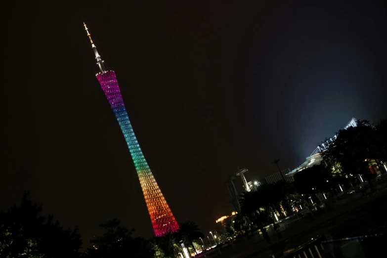 a very tall tower lit up at night, inspired by Cheng Jiasui, pexels contest winner, rasquache, rainbow colored, july 2 0 1 1, fan favorite, spaghettification