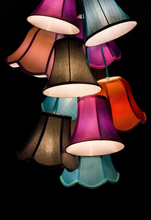 a bunch of lamps hanging from a ceiling, by Doug Ohlson, multicoloured, soft shade, bright on black, coloured photo