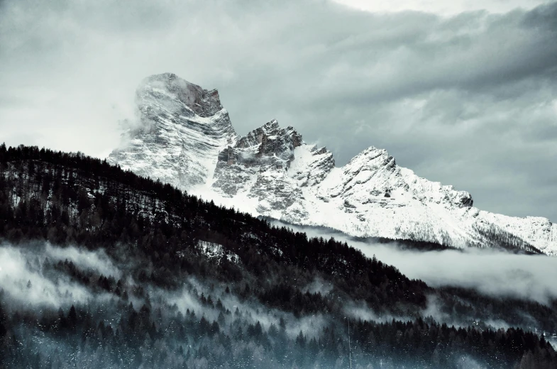 a black and white photo of a snow covered mountain, a matte painting, by Matthias Weischer, pexels contest winner, muted cold colors, 4 k hd wallpapear, a cozy, snapchat photo