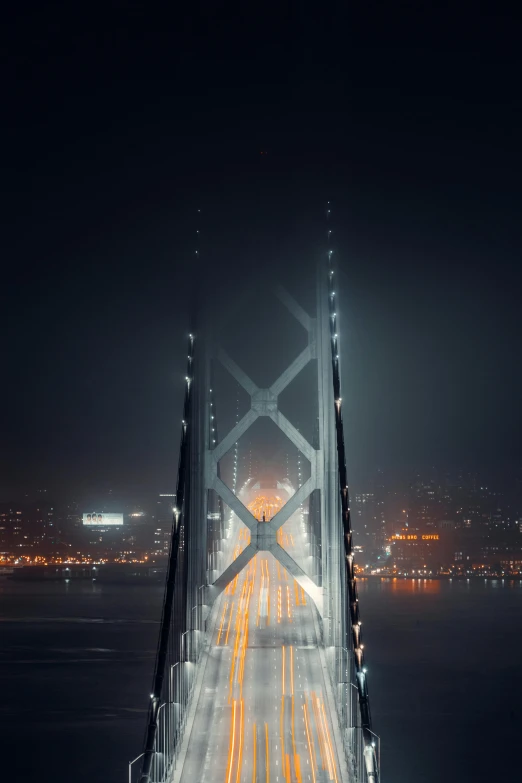 the golden gate bridge is lit up at night, pexels contest winner, hyperrealism, symmetrical!! sci-fi, foggy photo 8 k, tall building, architectural photograph