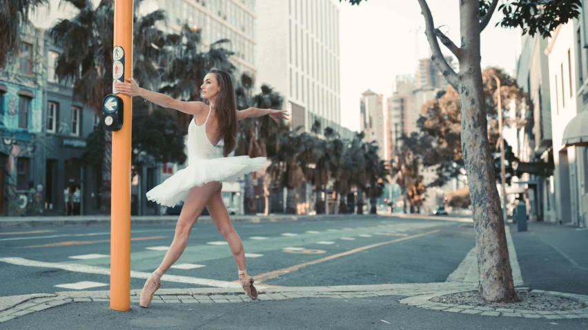 a woman in a white tutu dancing on a city street, inspired by Elizabeth Polunin, pexels contest winner, arabesque, square, bay area, profile image, angela sarafyan