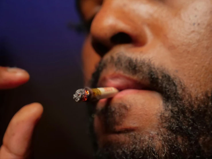 a man with a cigarette in his mouth, ray lewis, thc, ap photo, bokeh ”