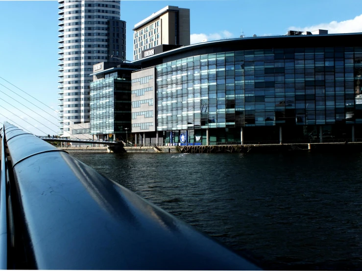 a bridge over a body of water next to tall buildings, manchester, slide show, gigapixel photo