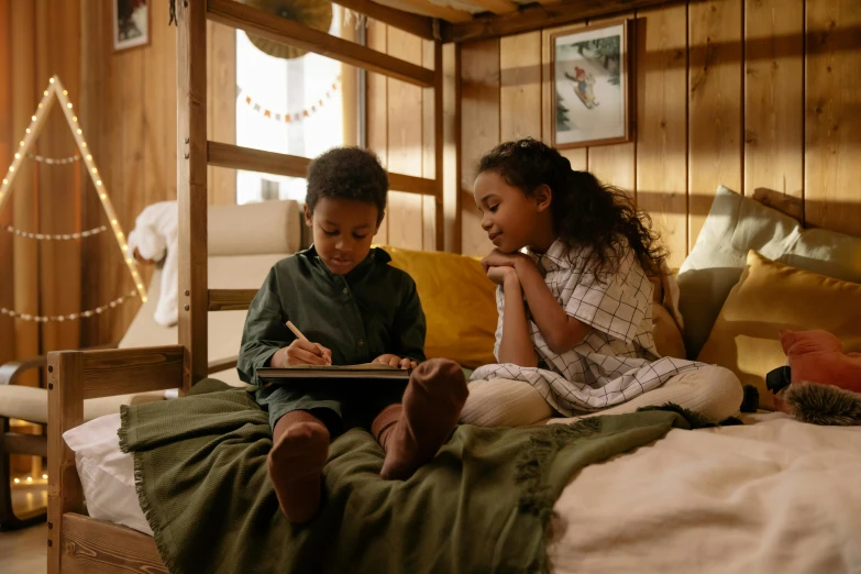 a couple of kids sitting on top of a bed, a child's drawing, inspired by Jessie Newbery, pexels contest winner, arts and crafts movement, cozy treehouse bedroom, drawing sketches on his notebook, draw with wacom tablet, cosy