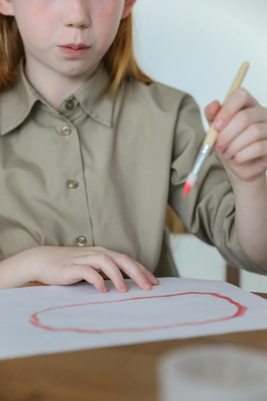 a little girl sitting at a table with a pencil and paper, inspired by Helen Frankenthaler, pexels, wearing a red captain's uniform, pencil marks hd, mid shot, an abstract