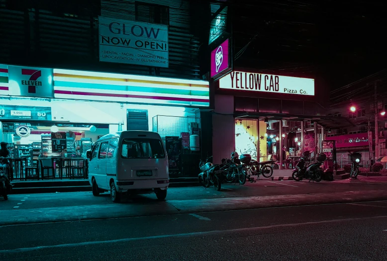 a white van parked on the side of a road, inspired by Elsa Bleda, pexels contest winner, neon shops, yelow, nightcafe, yellow and black