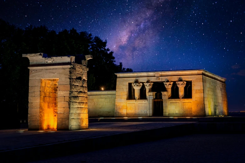 a building lit up at night with the milky in the background, egyptian art, by Julia Pishtar, unsplash contest winner, hurufiyya, doors that are cosmic portals, sitting in a cemetery at night, washington dc, set in observatory at night