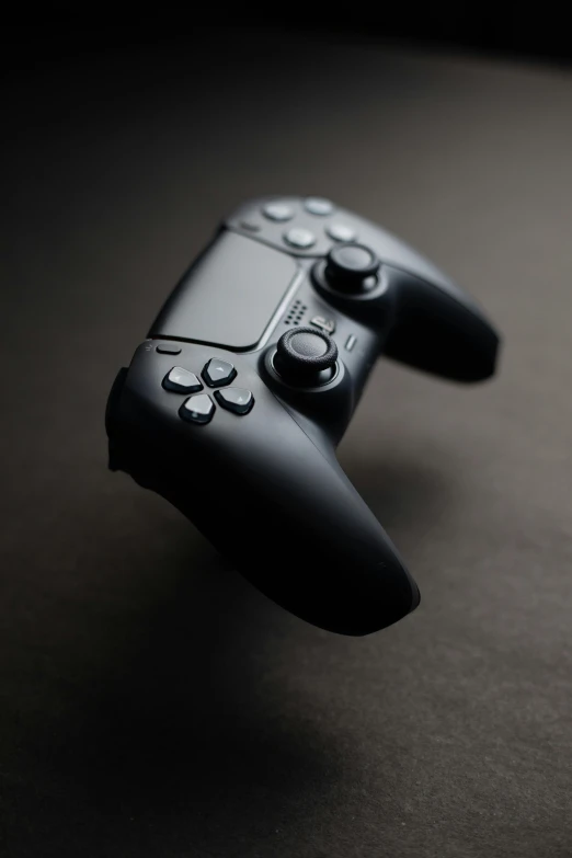 a close up of a video game controller, pexels, minimalism, square enix, black, educational, slate