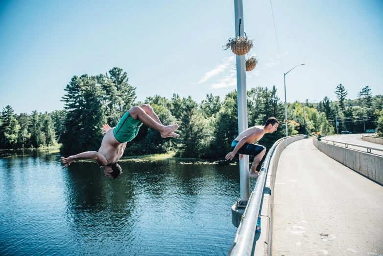 two men jumping off a bridge into a body of water, an album cover, by Carey Morris, unsplash, happening, new hampshire, summer street, profile image