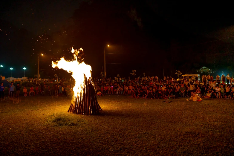 a group of people watching a fire show, pexels contest winner, land art, extreme panoramic, high school, fuming effigy, award winning masterpiece photo