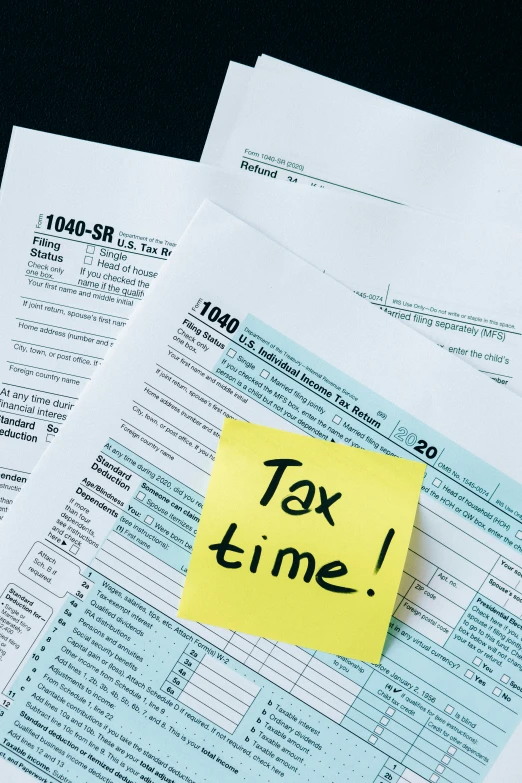 a piece of paper with the words tax time written on it, by Adam Rex, pexels contest winner, square, stacks, color picture, kailee mandel