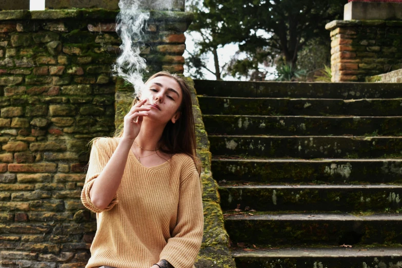 a woman sitting on steps smoking a cigarette, trending on pexels, renaissance, weed background, lush surroundings, college girls, twisting vapour