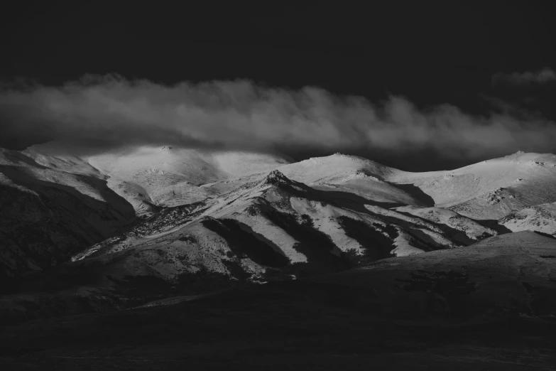 a black and white photo of snow covered mountains, a black and white photo, by Emma Andijewska, unsplash contest winner, baroque, dark volcano background, today\'s featured photograph 4k, somber colors, iphone wallpaper