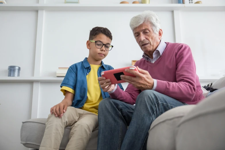 an older man and a young boy sitting on a couch, pexels contest winner, pixel art, holding a nintendo switch, school class, old man, maintenance photo