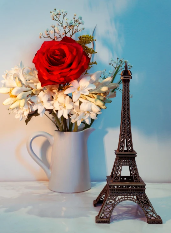 a vase of flowers and a statue of the eiffel tower, fully decorated, product shot, petite, mid shot
