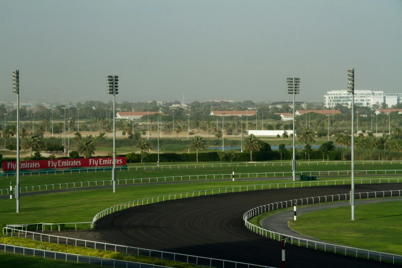 a view of a race track from the top of a hill, hurufiyya, mohamed chahin, galloping, winning photograph