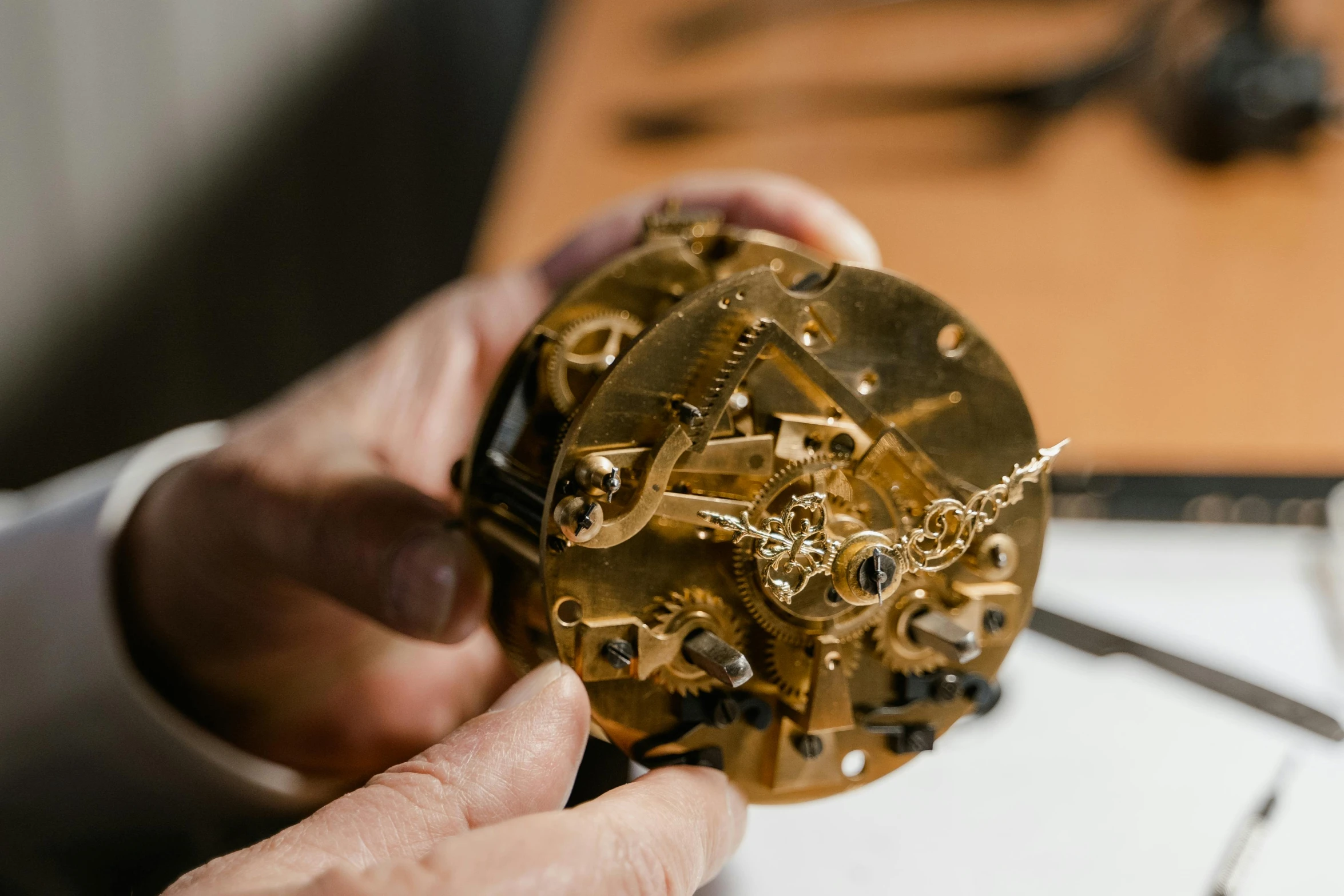 a close up of a person holding a clock, an engraving, assemblage, inspect in inventory image, cogs and springs and jewels, thumbnail, brown